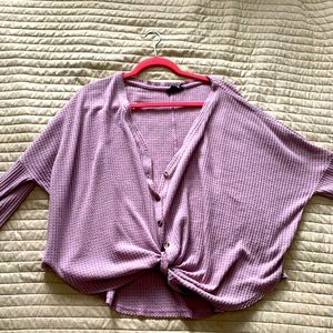 Medium out front under tied shirt. Great for breast feeding. Used
